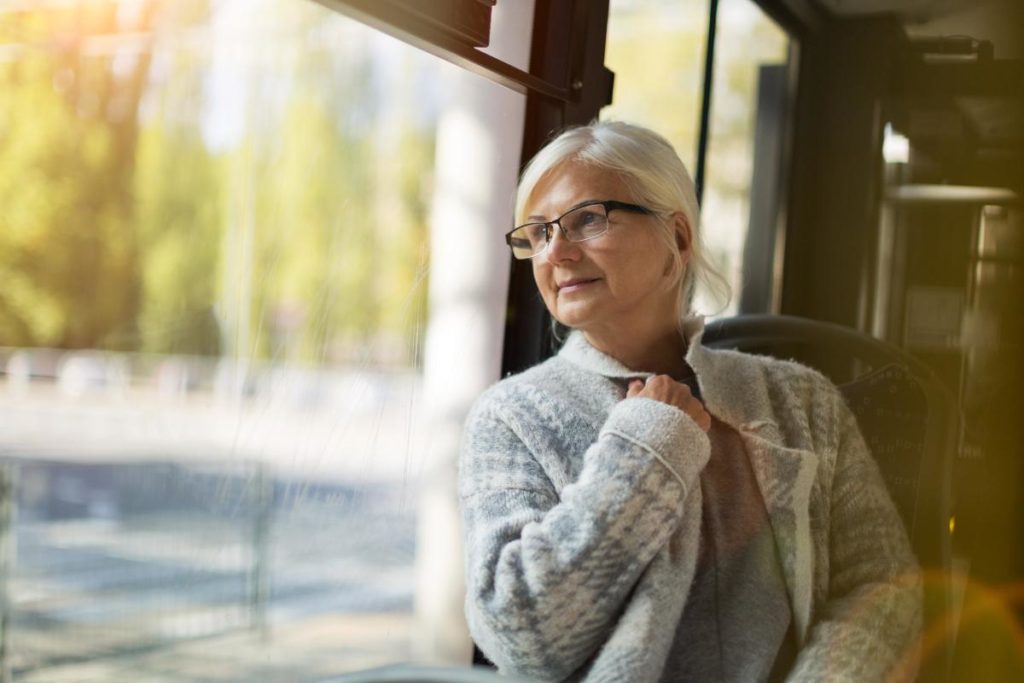 older woman starting out window waiting for transportation services