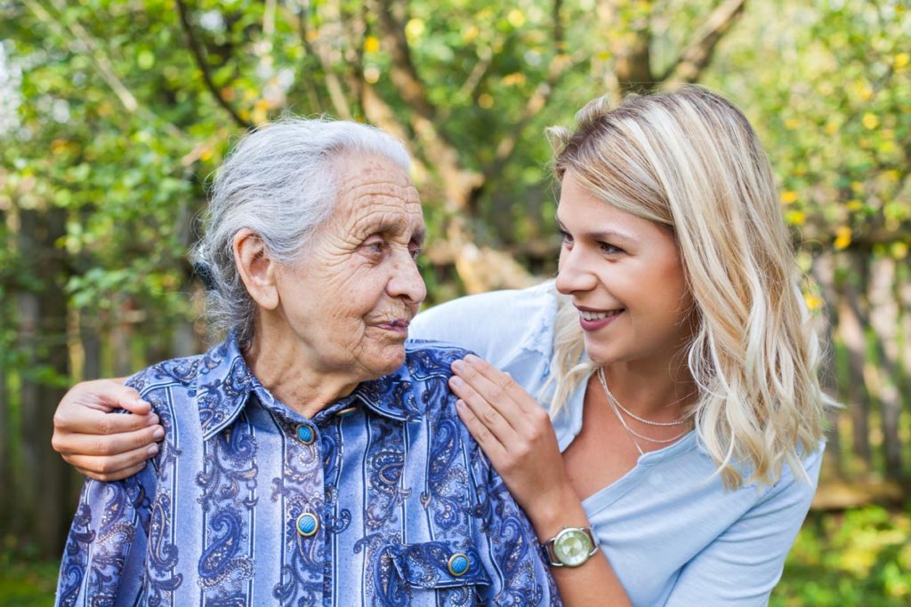 young woman checking loved one into a memory care facility