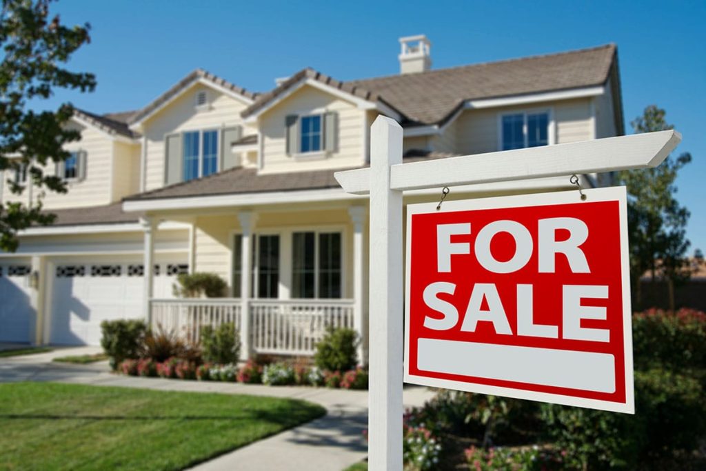 image of a home with for sale sign in the front yard symbolizing how to sell your aging parents home