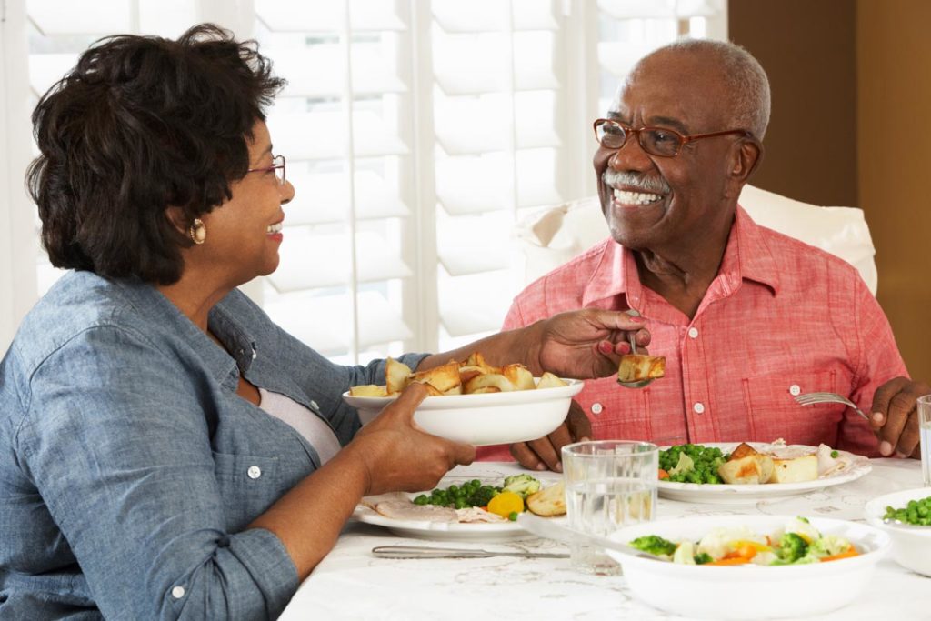 a married senior couple sitting down to enjoy easy low sodium meals for senior heart health