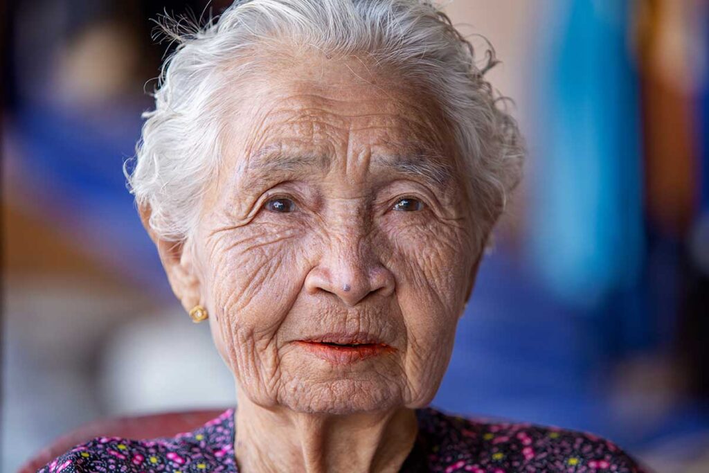 close up of elderly woman staring vacantly and demonstrating one of 5 common behaviors of dementia