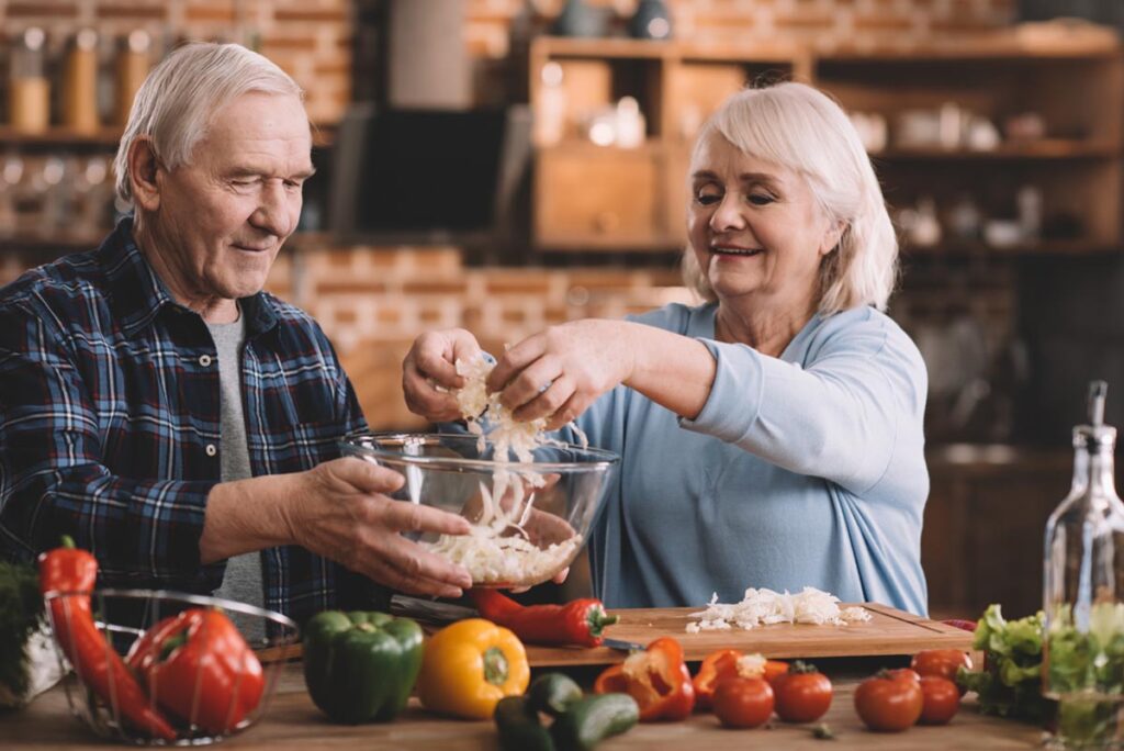 a senior couple enjoys a meal after finding healthy recipes for elderly people