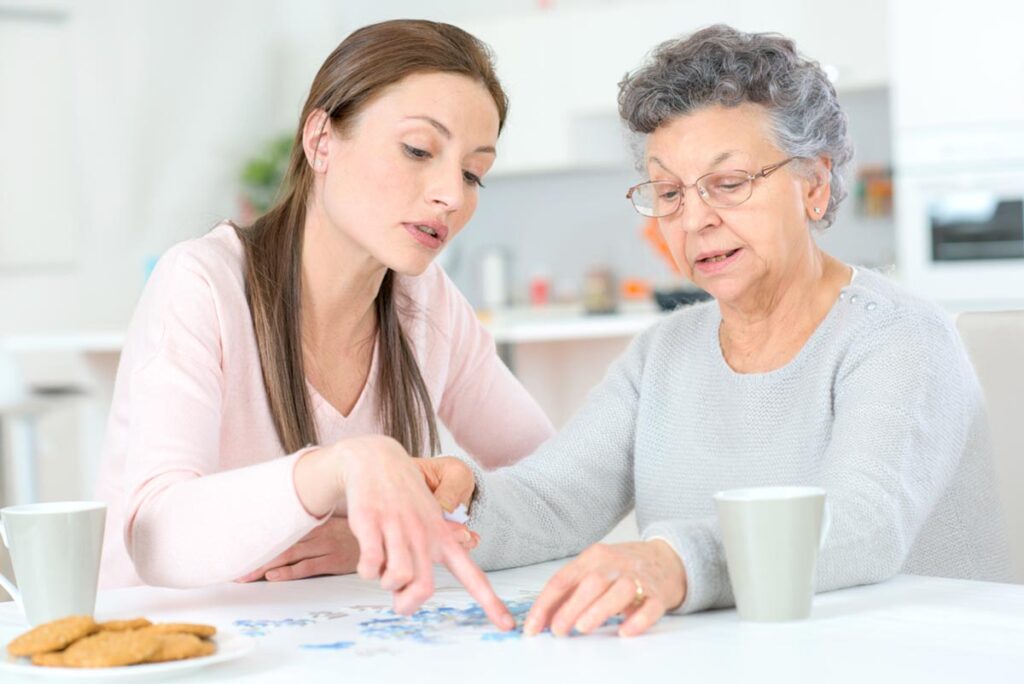 a caregiver talks with a senior about respite care for elderly dementia patients