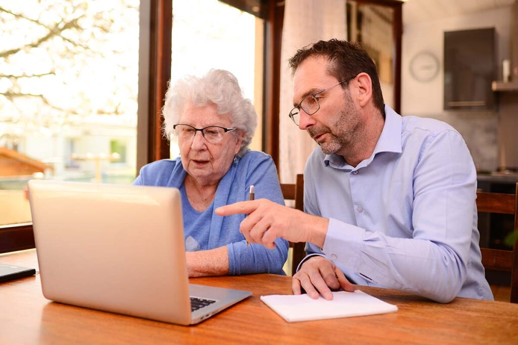 middle-aged man explaining to elderly woman the average cost of respite care