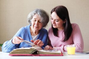 an adult child helps their senior parent read a list of what to bring to memory care