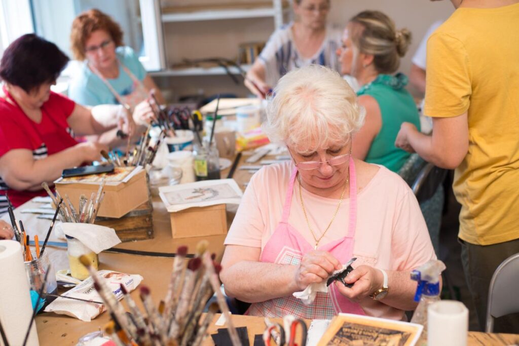 a resident paints, one of many craft activities for seniors