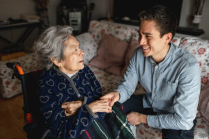 an adult child comforts a senior parent as they prepare for respite care