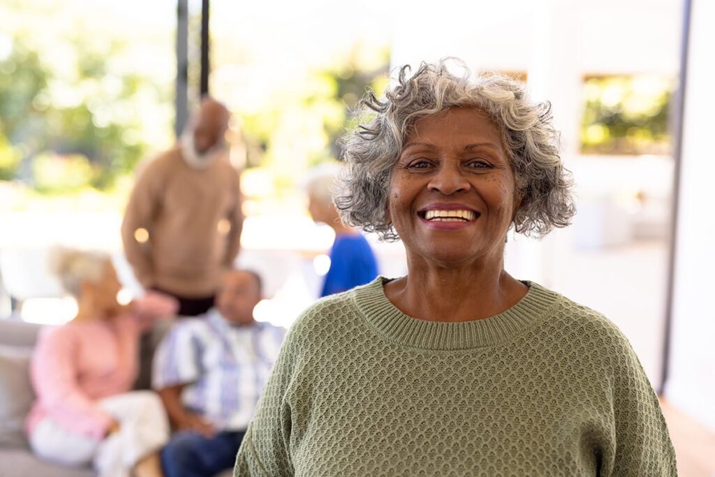 a senior smiles after learning what senior assisted living is