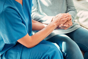 how much does respite care cost in Longview, TX explained by nurse holding the hand of a senior