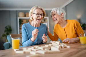 Two women play simple games for dementia patients