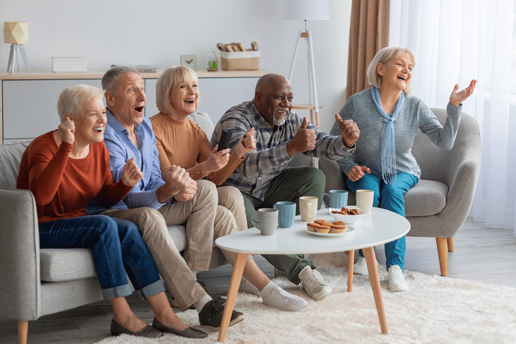 senior living residents watch a movie together