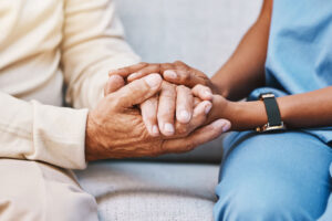 a cna comforts a resident in senior living